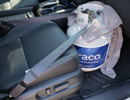 transporting propane cylinder seat belted in the back seat of a car