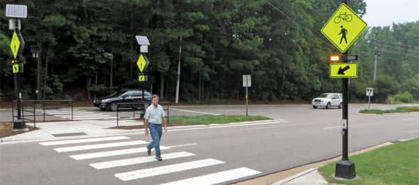 crosswalk with flashing yellow pedestrian beacon