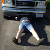 image of man doing work on a truck at the roadside