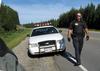 Police Officer approaching from behind driver